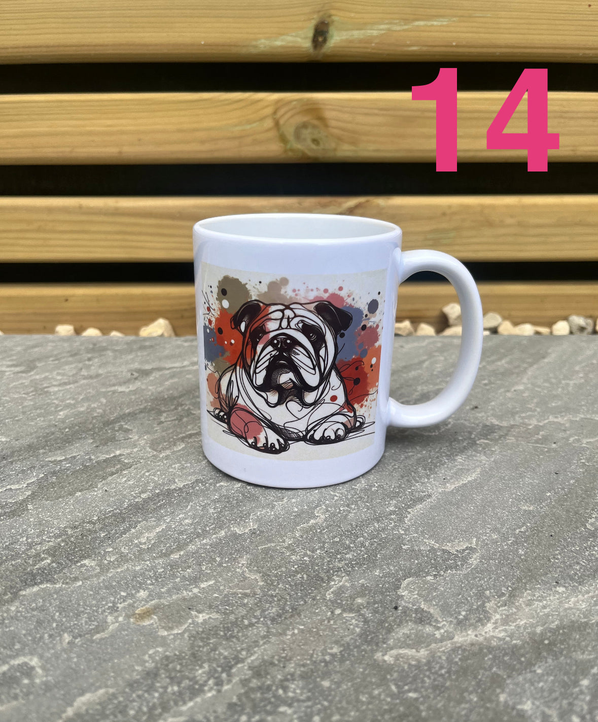 White mug with a dog illustration on a stone surface with wooden planks in the background
