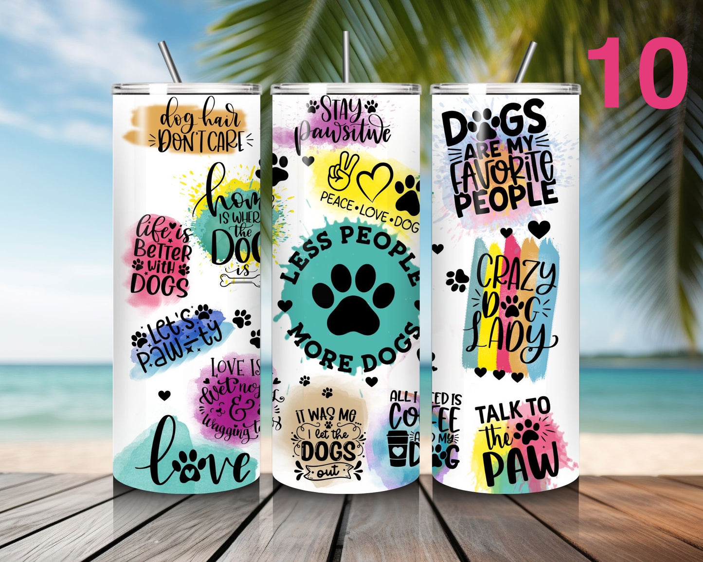 Three tumblers with dog-themed designs on a wooden surface with a beach background.