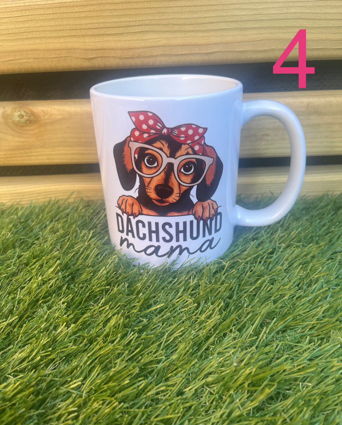Mug with dachshund design and 'Dachshund mama' text on grass and wooden surface