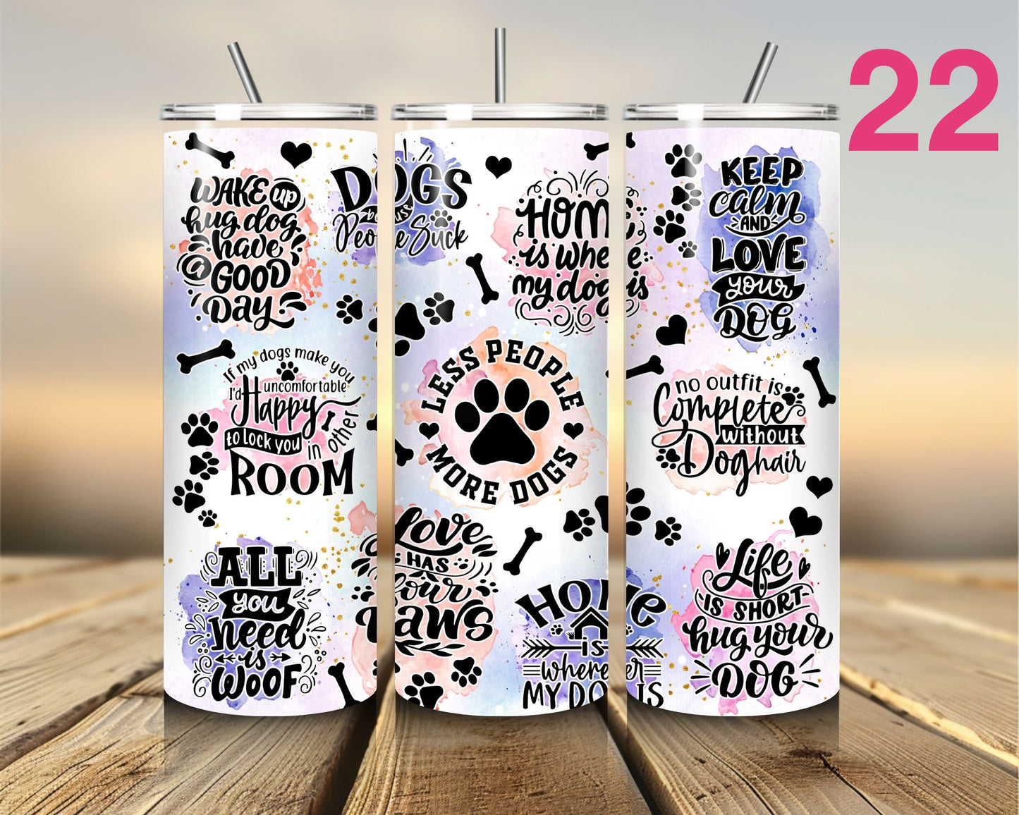 Four tumblers with dog-themed designs on a wooden surface.