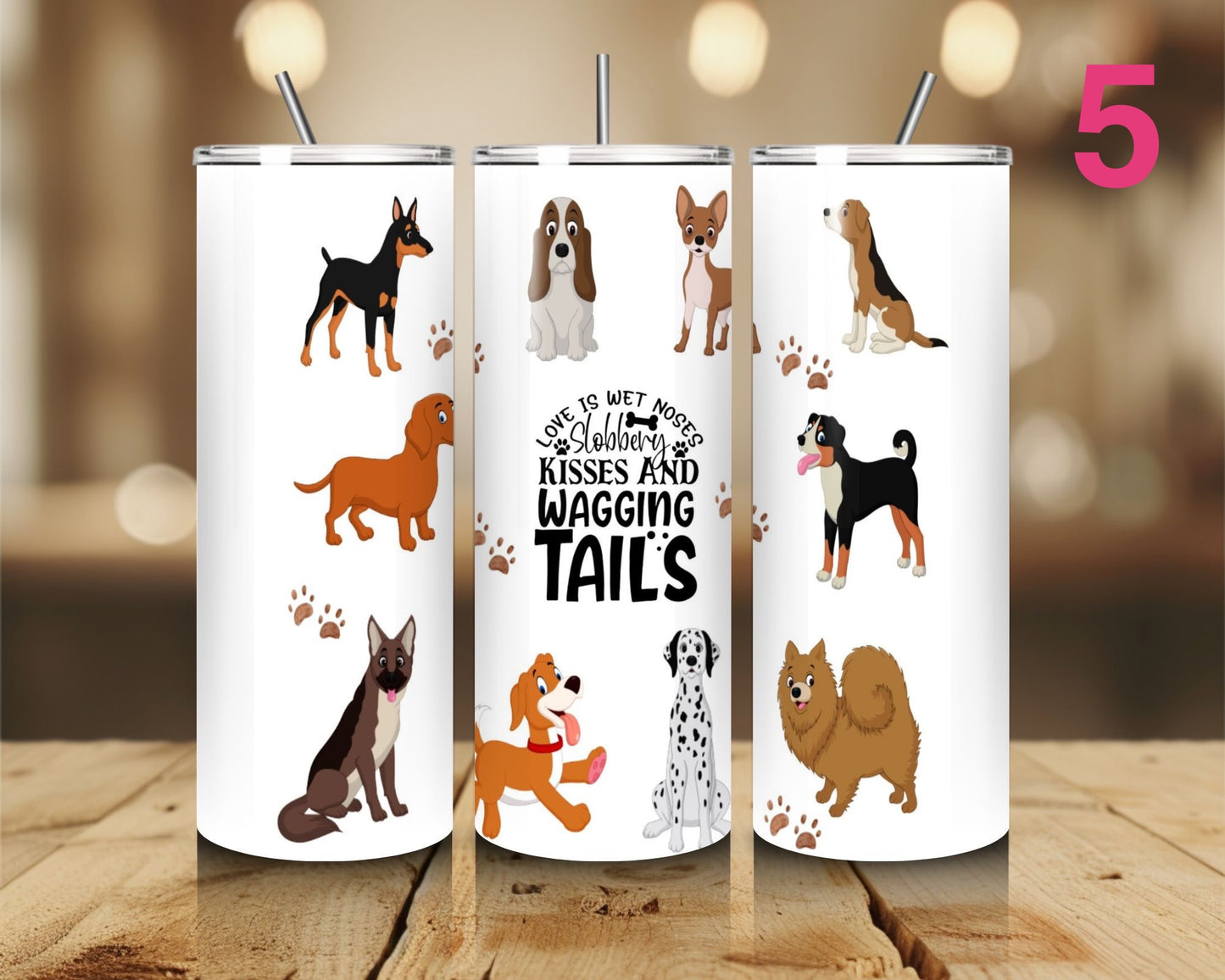 Three tumblers with dog illustrations and text on a wooden surface.
