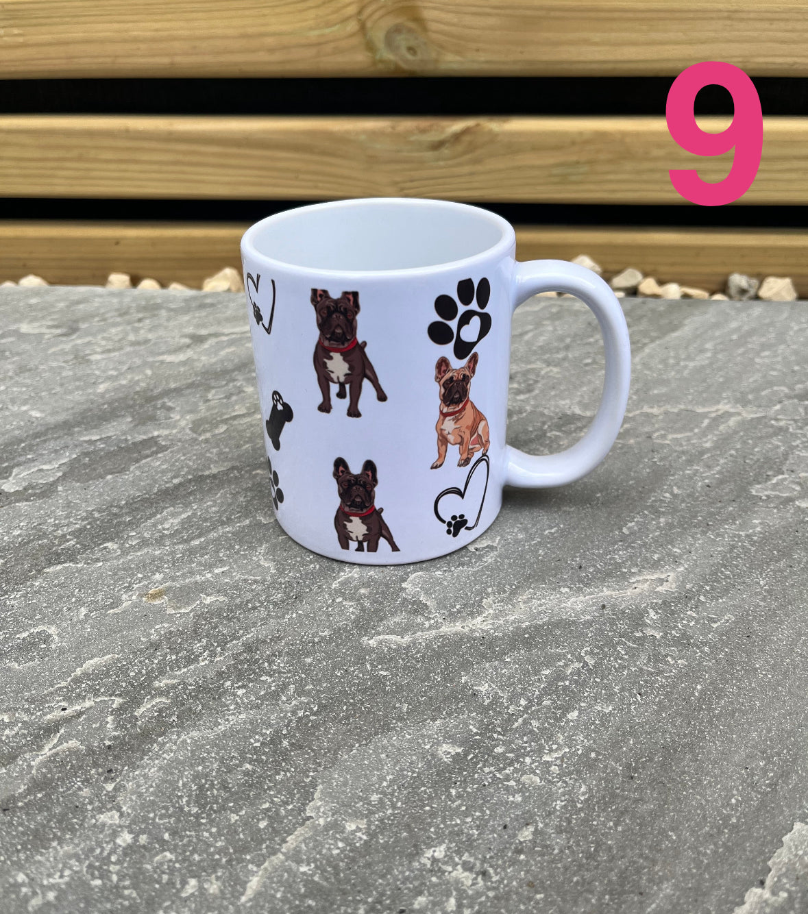 White mug with dog illustrations on a stone surface