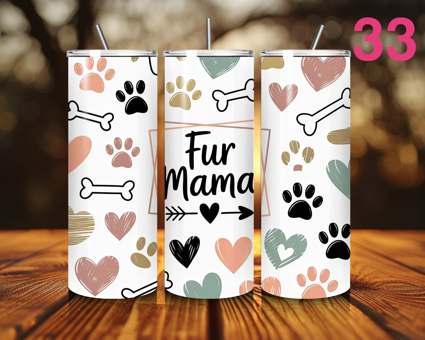 Three tumblers with paw print and bone designs on a wooden surface.