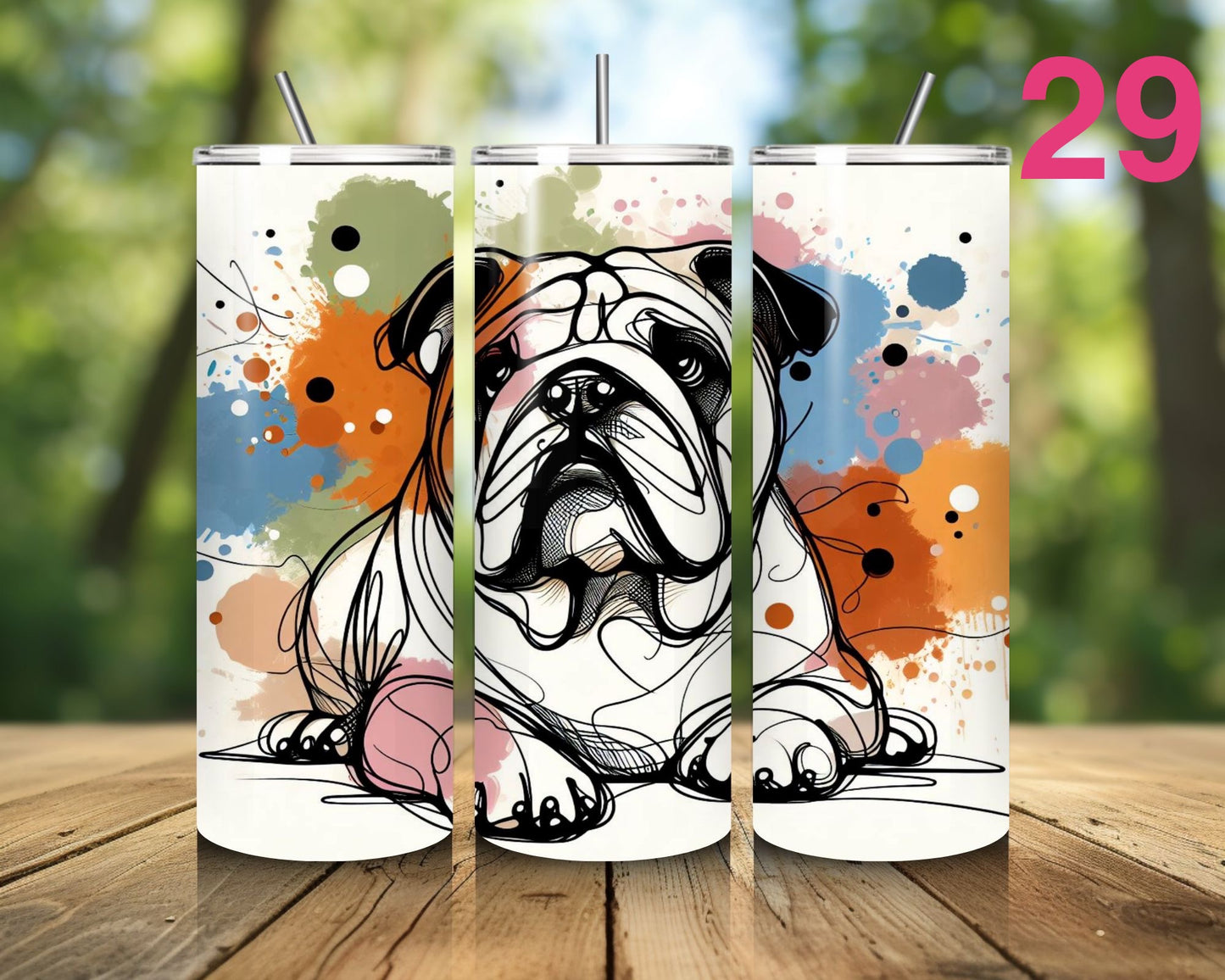 Three tumblers with a bulldog design on a wooden surface with a blurred natural background.