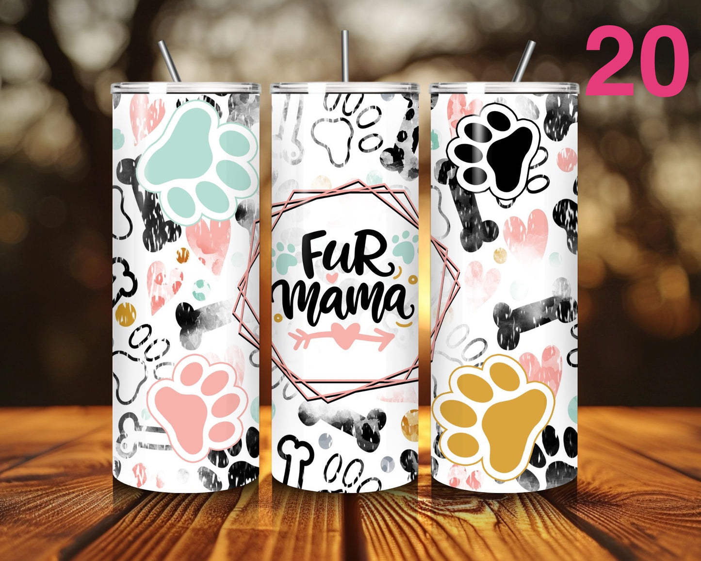 Three tumblers with paw print designs on a wooden surface.