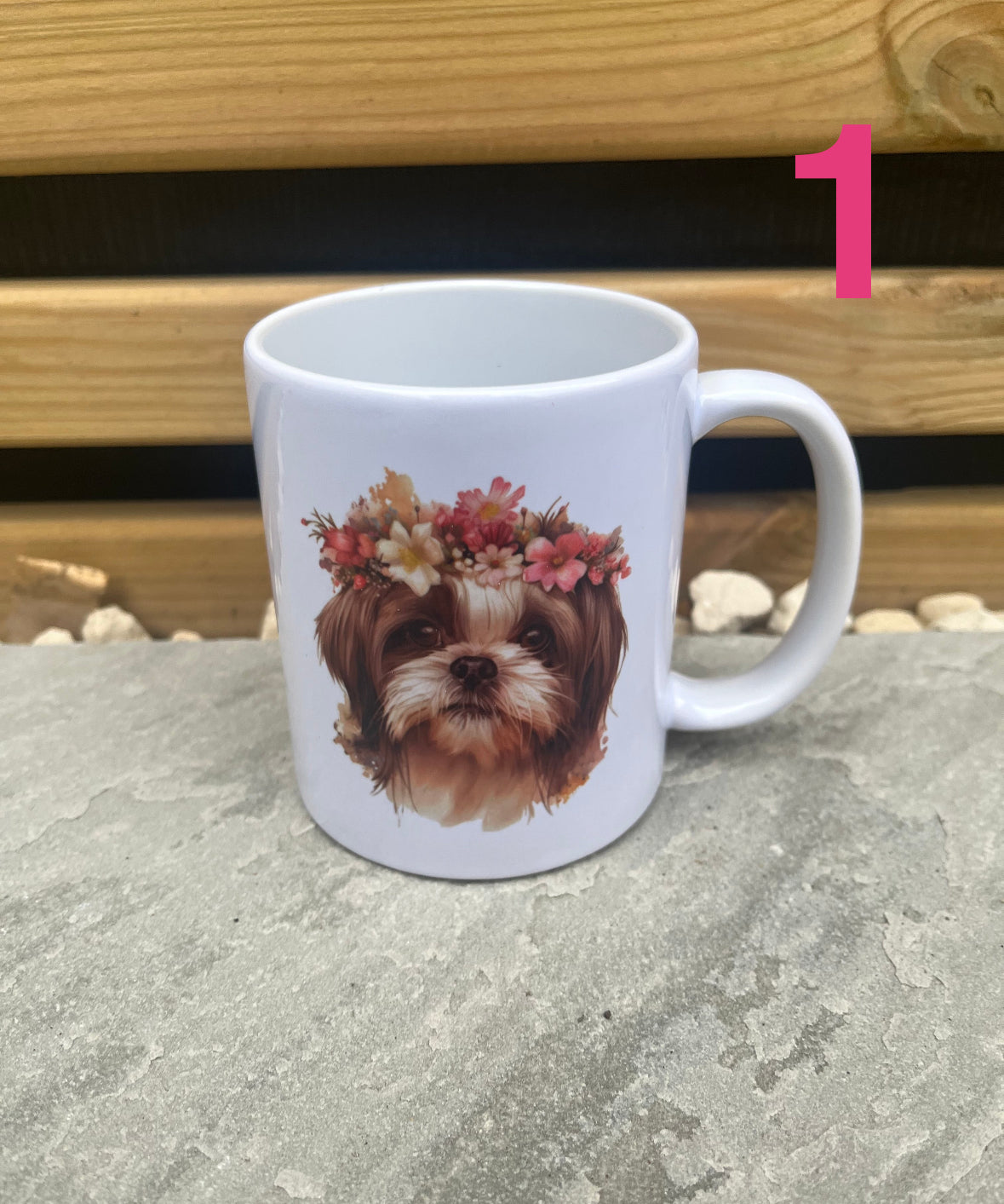 White mug with a dog's face wearing a floral crown design on a stone surface.