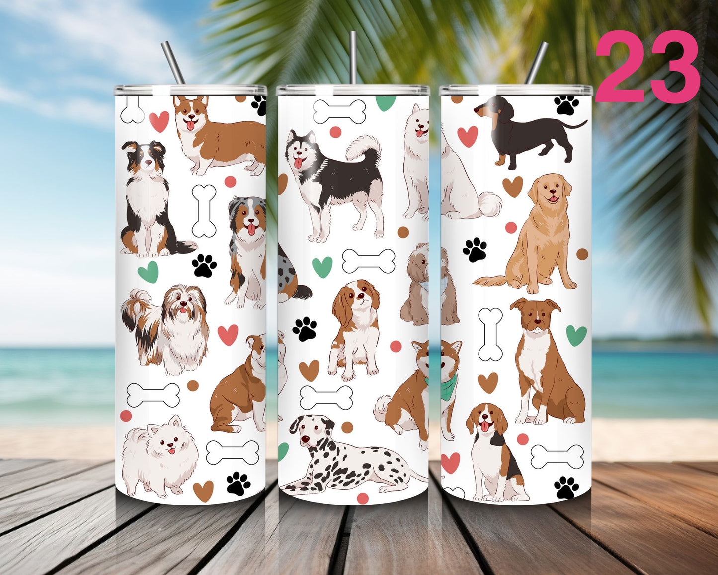Three tumblers with dog pattern designs on a wooden surface with a beach background.