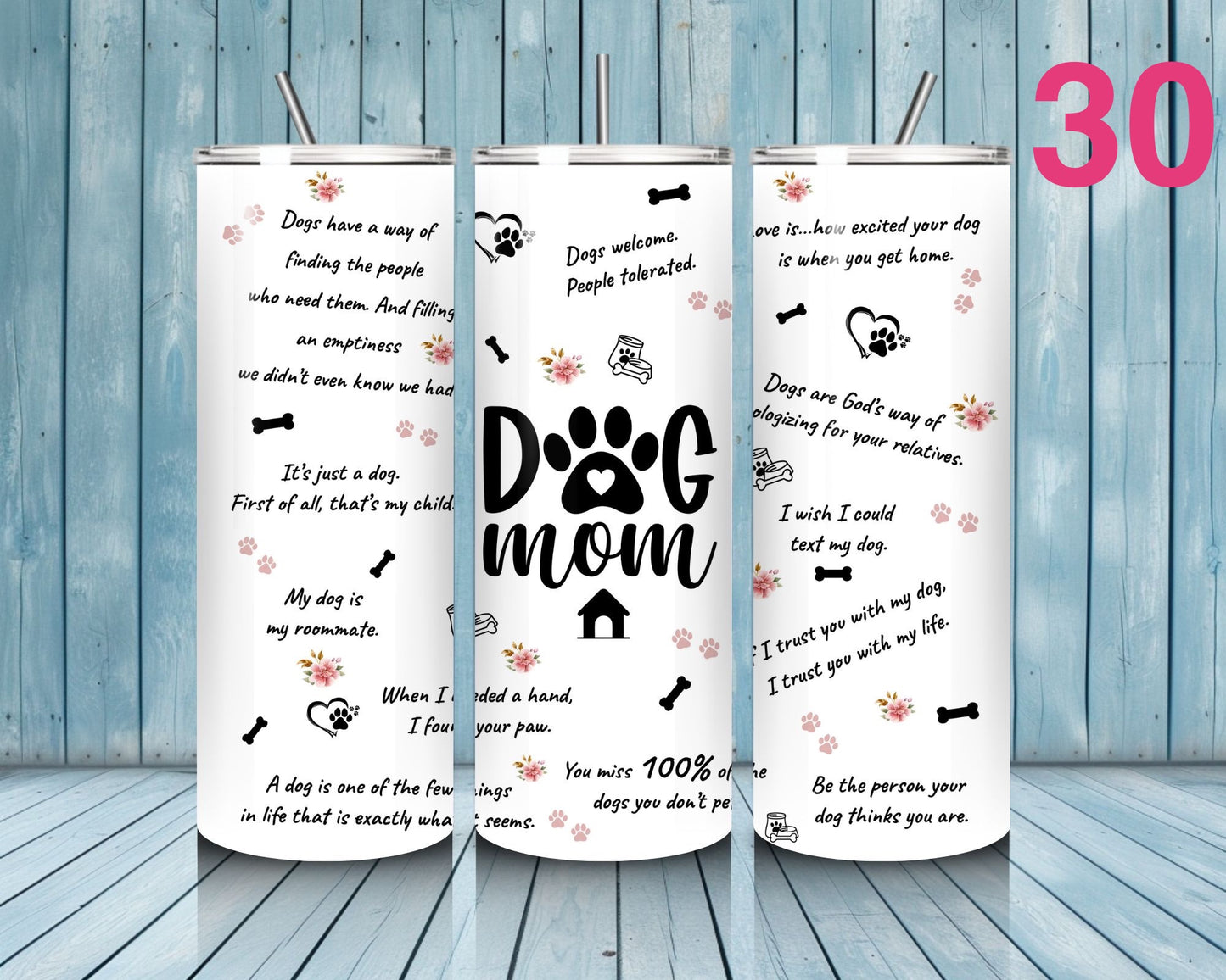 Three tumblers with text and dog-themed graphics on a wooden floor and blue wooden wall background.