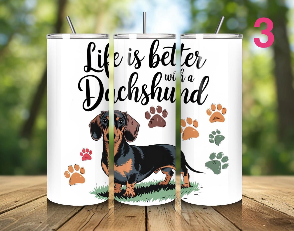 Tumbler with dachshund design and text 'Life is better with a Dachshund' on a wooden surface.