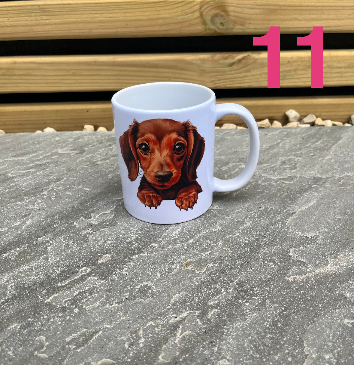 Mug with a dachshund design on a stone surface with a wooden background