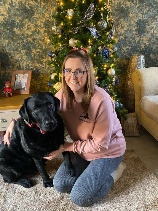 Woman wearing personalised peeking dog sweatshirt with black dog