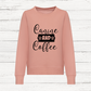 Pink sweatshirt with 'Canine and Coffee' text on a wooden background