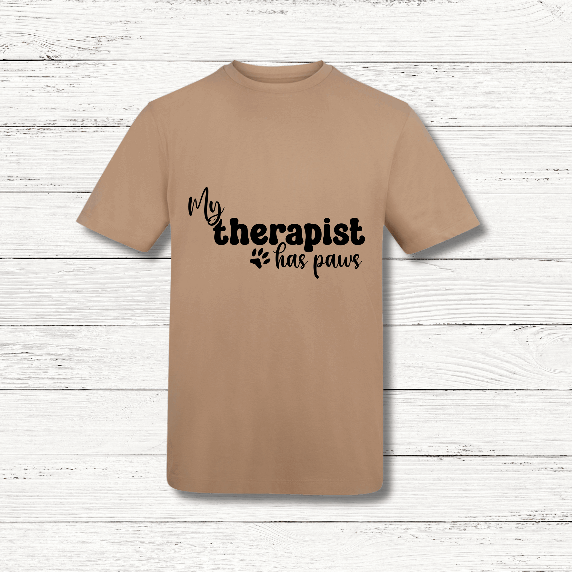 Beige t-shirt with 'My therapist has paws' text on a wooden surface