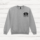 Gray sweatshirt with a dog illustration and text on a wooden surface