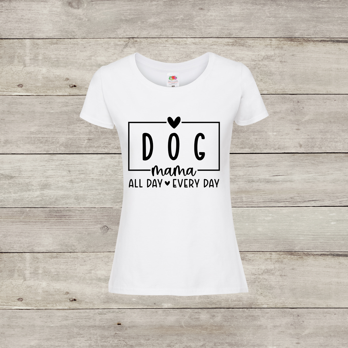 White t-shirt with 'DOG mama ALL DAY EVERY DAY' text on a wooden surface