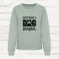 Light green sweatshirt with 'Busy Being a Dog Mama' text on a white wooden background