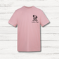Pink t-shirt with a dog illustration and text on a wooden surface