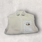 Light gray fleece gilet with a patch on a light gray background