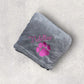Gray blanket with pink paw print and 'Tiddler' text on a light gray background