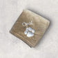 Brown towel with 'Opal' and paw print on a light gray background