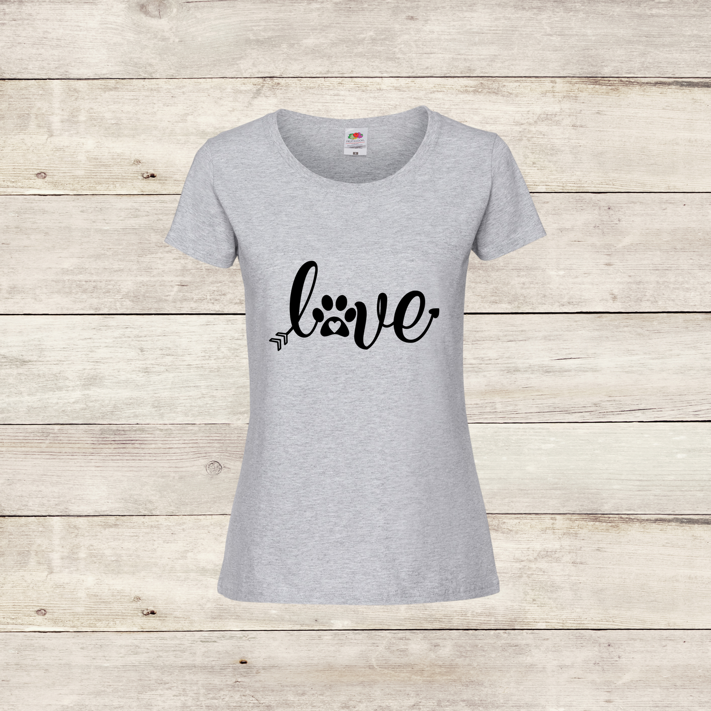 Gray t-shirt with 'love' and paw print design on a wooden surface