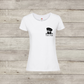 White t-shirt with a dog graphic and text on a wooden surface