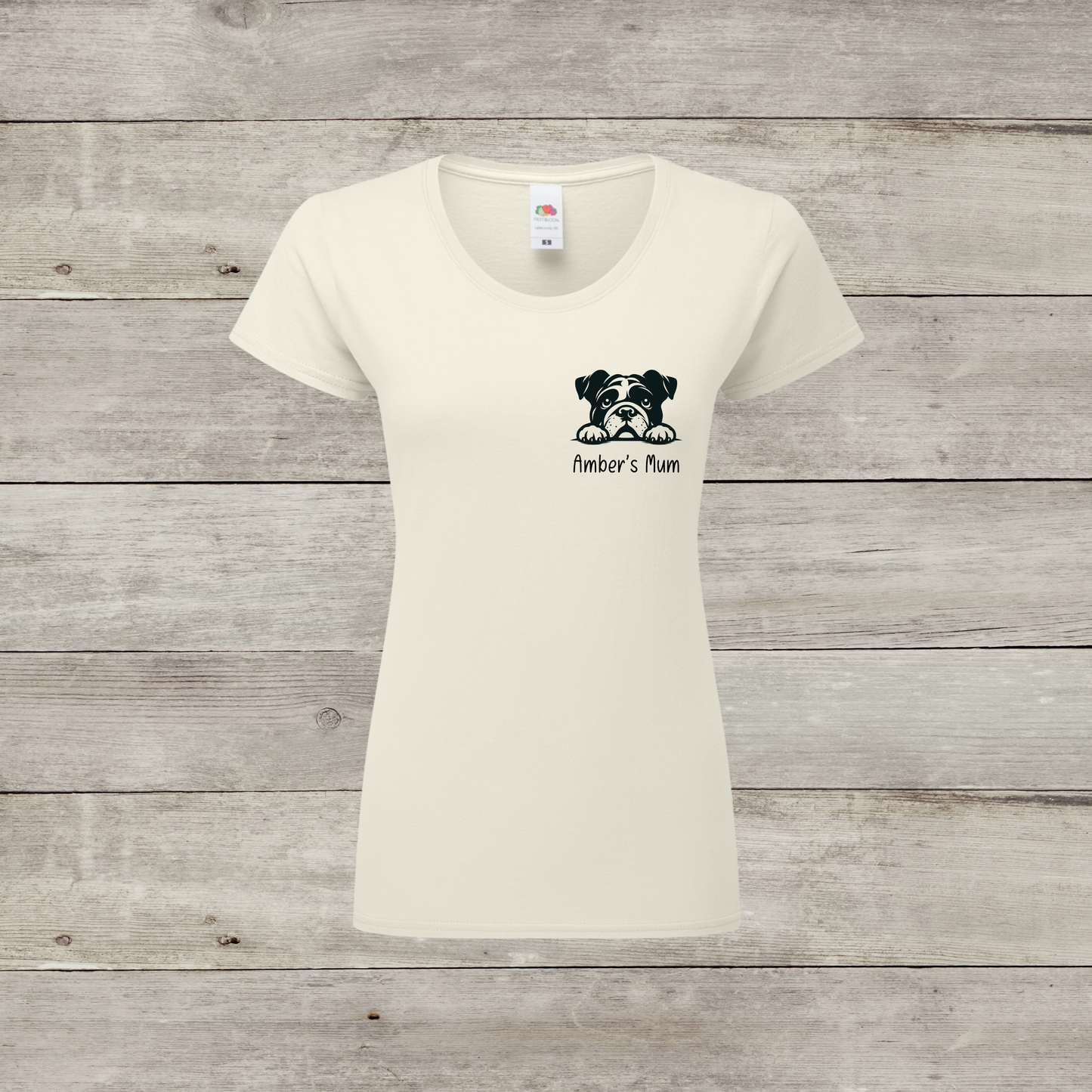 White t-shirt with a dog graphic and text on a wooden surface
