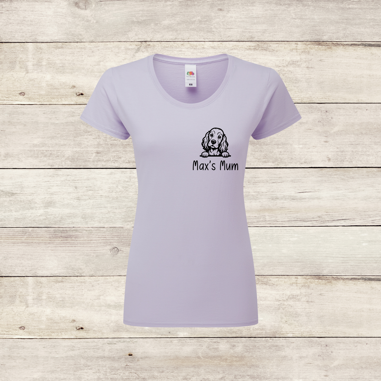 Lavender t-shirt with a dog illustration and text on a wooden surface