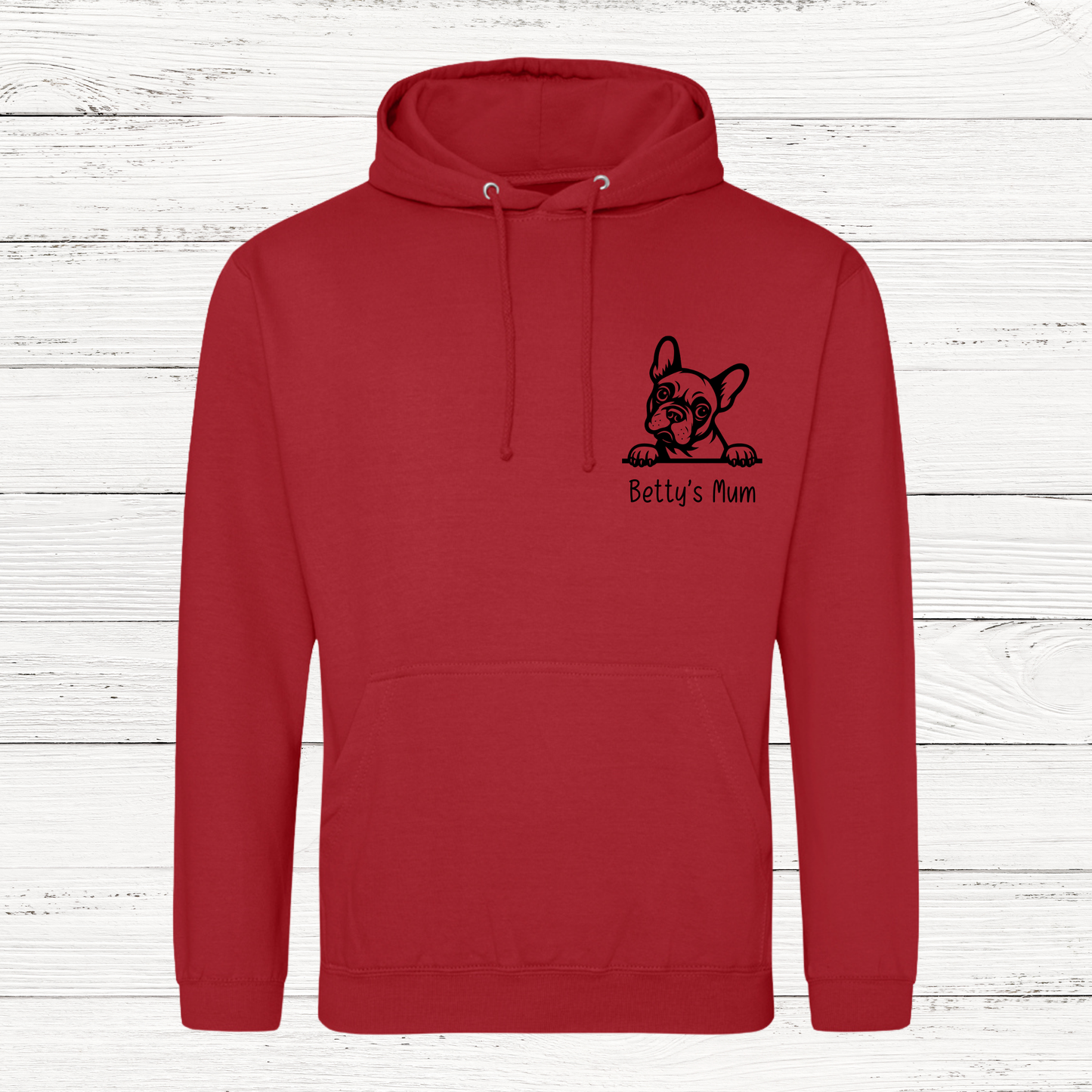 Red hoodie with a black dog illustration and text on a white wooden background
