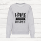 Gray sweatshirt with 'Home is wherever my dog is' text on a white wooden background