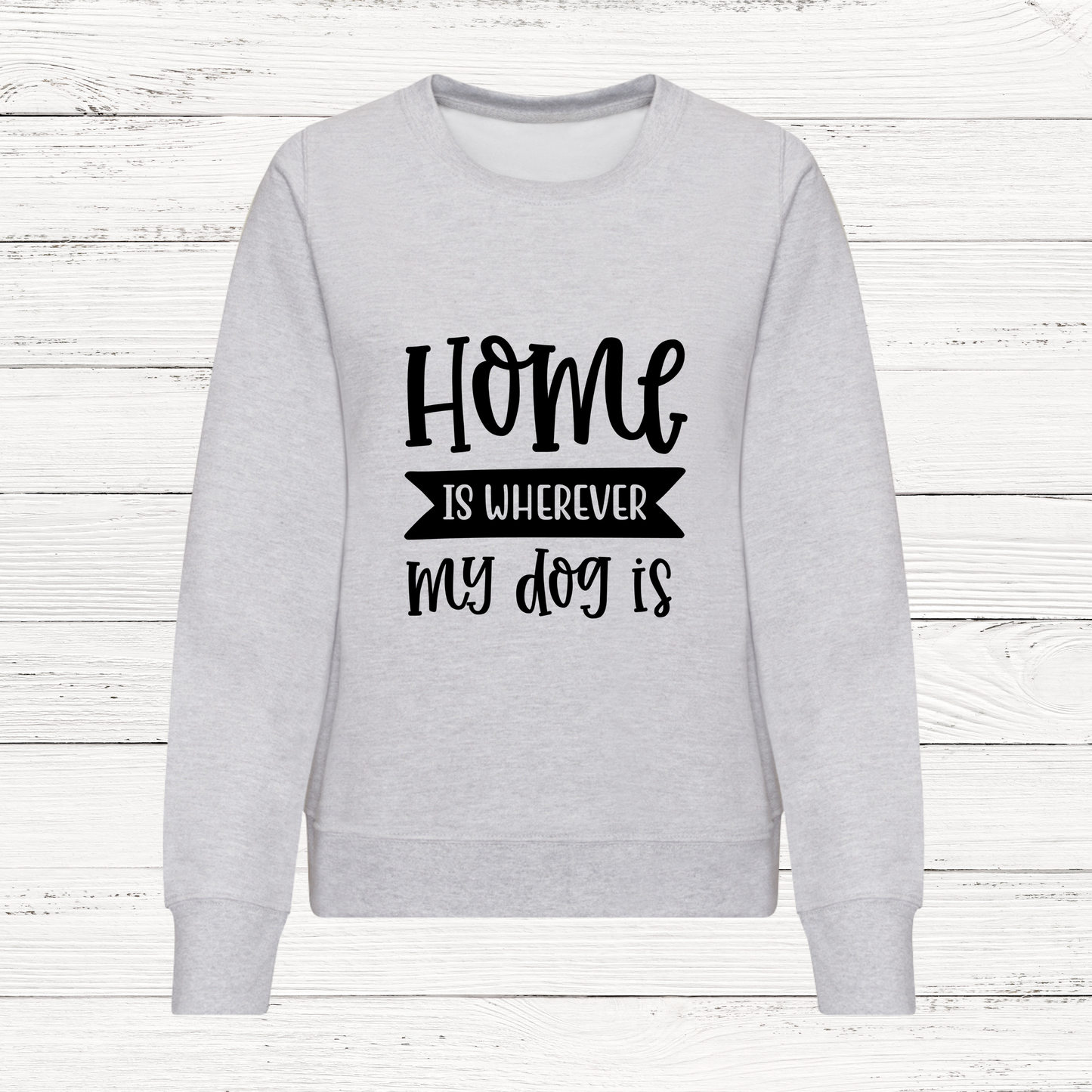Gray sweatshirt with 'Home is wherever my dog is' text on a white wooden background