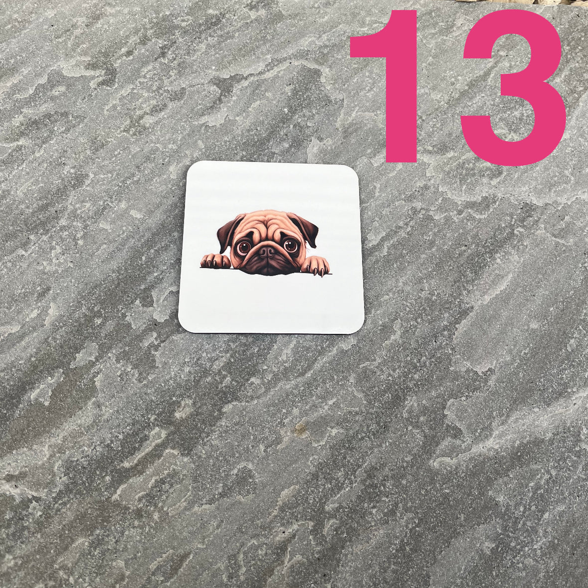 Coaster with a pug design on a textured gray surface