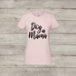 Pink t-shirt with 'Dog Mama' text on a wooden surface