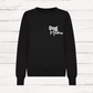 Black sweatshirt with 'Dog Mum' text on a white wooden background