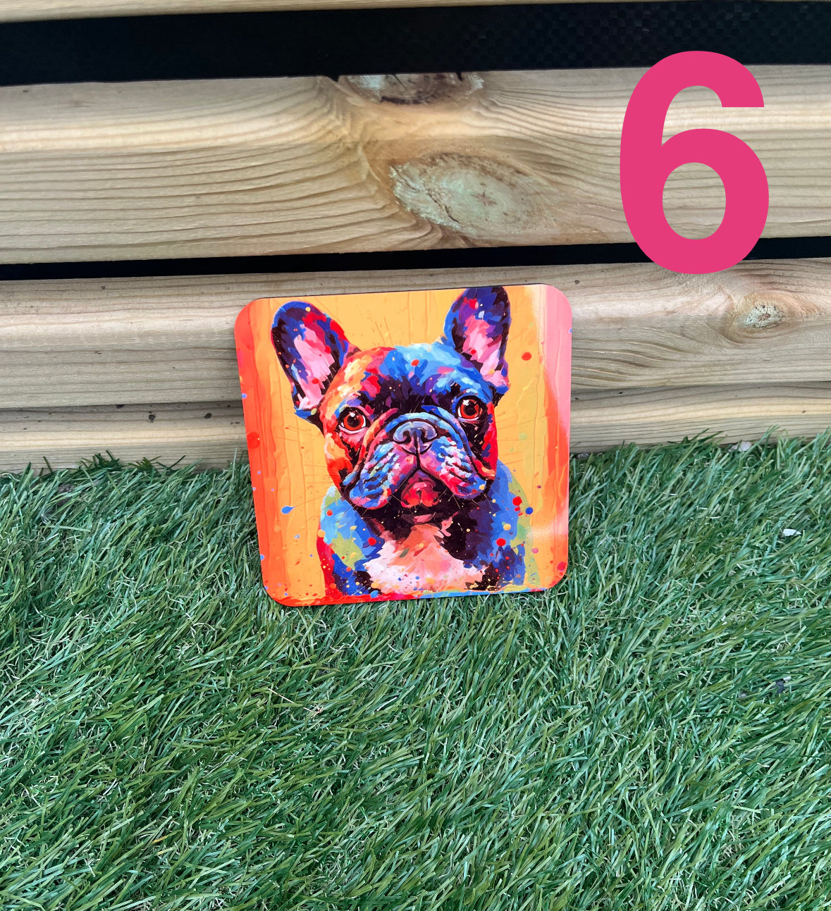 Colorful painting of a dog on a wooden surface with grass below