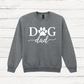 Gray sweatshirt with 'Dog Dad' text on a wooden surface
