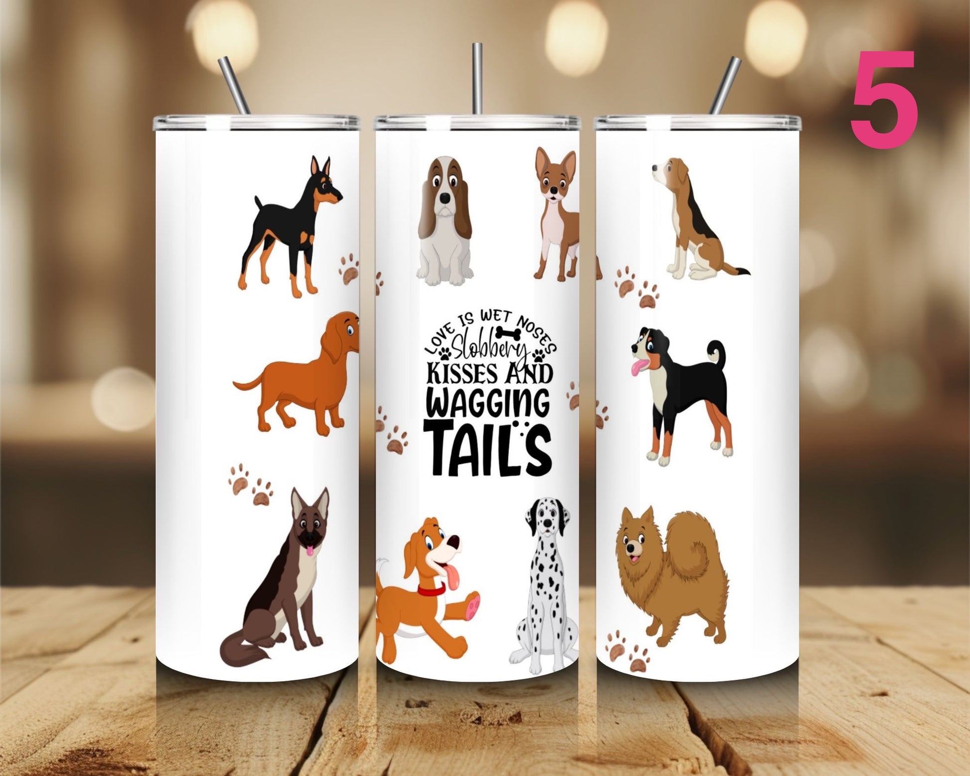 Three tumblers with dog illustrations and text on a wooden surface.