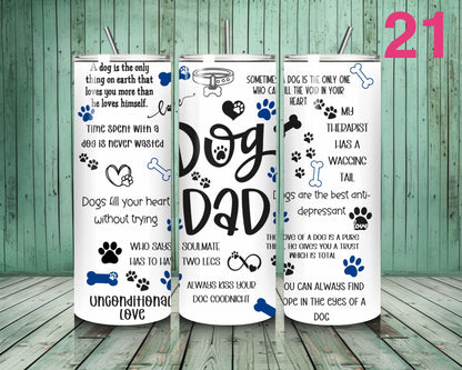 Three white tumblers with dog-themed text and graphics on a wooden floor.