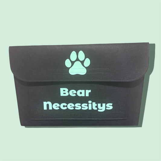Black pouch with a paw print and 'Bear Necessitys' text on a light green background