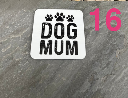 Sticker with 'DOG MUM' text and paw prints on a stone surface.