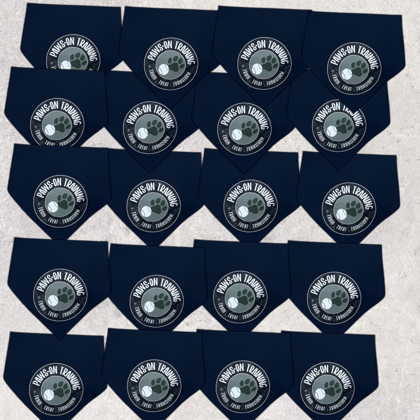 Multiple black dog bandanas with a central logo on a light gray background