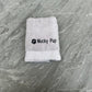 Folded towel with 'Mucky Pup' text on a textured surface