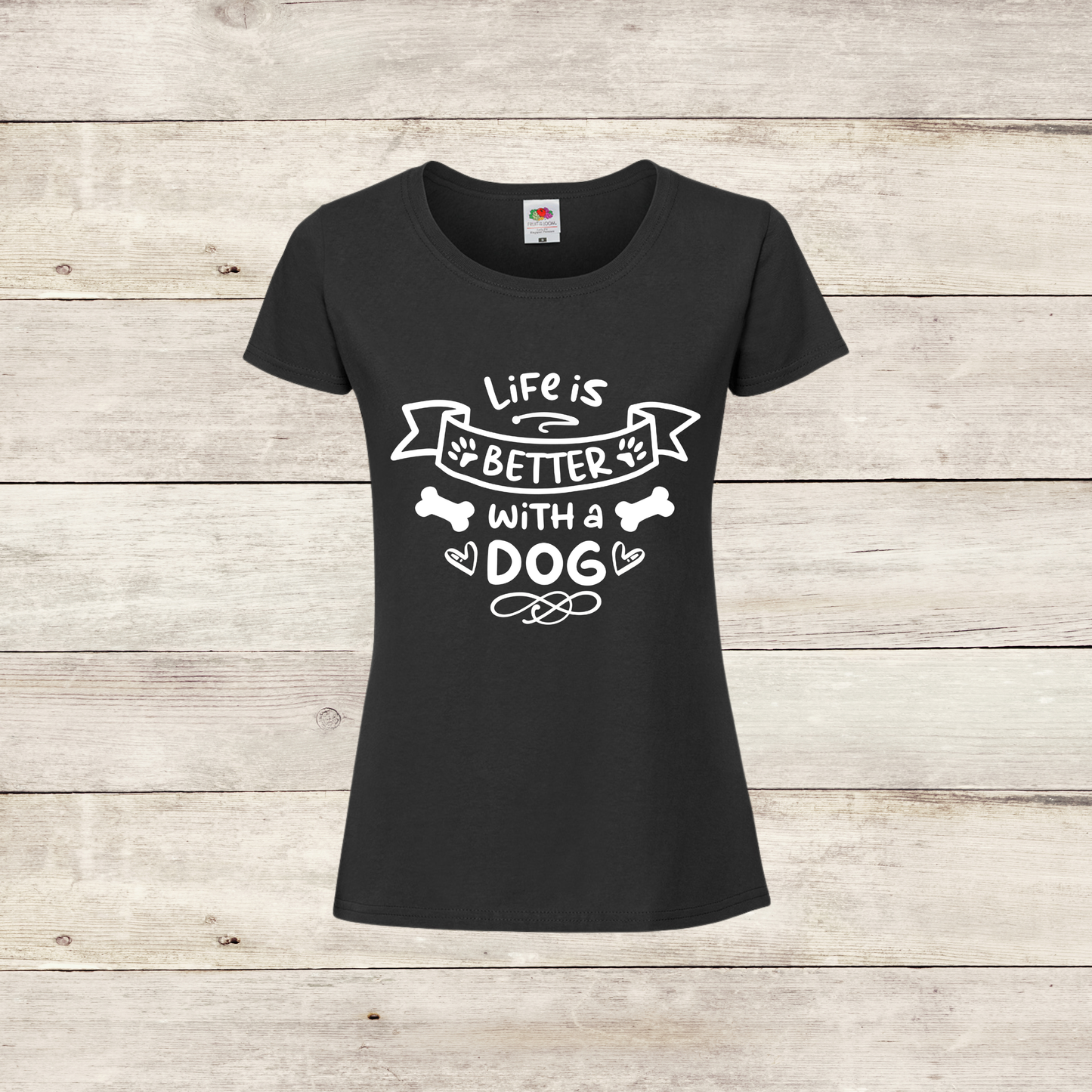 Black t-shirt with 'Life is better with a dog' text on a wooden background
