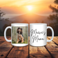 Two mugs on a wooden surface with one featuring a dog photo and the other 'Maeve's Mama' text, against a sunset background.