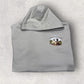 Gray hoodie with a logo on the chest against a light gray background