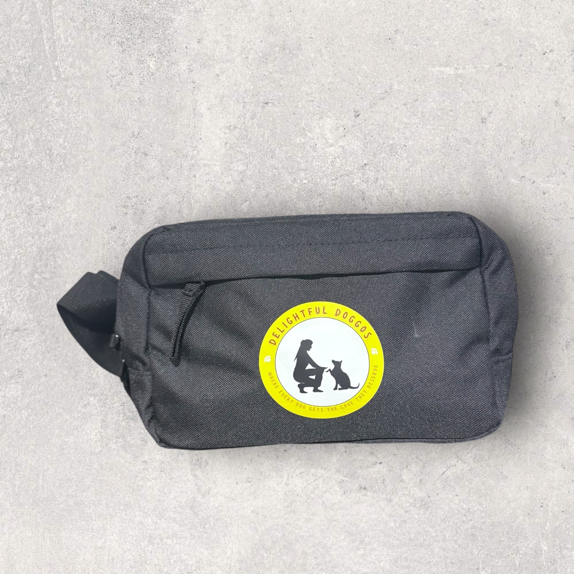 Black waits bag with a circular logo featuring a silhouette of a person and a dog on a light gray background