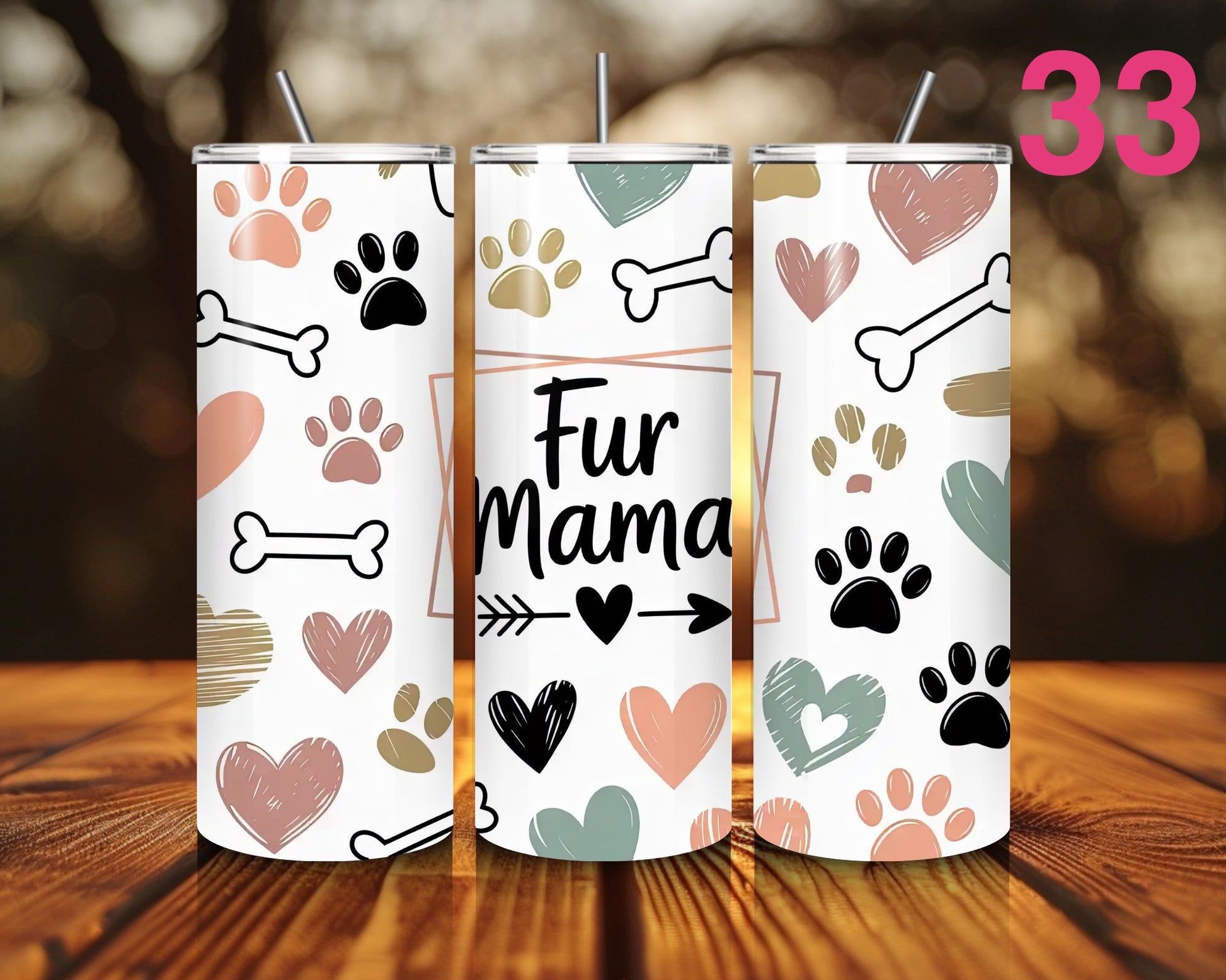 Three tumblers with paw print and bone designs on a wooden surface.