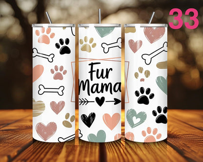 Three tumblers with paw print and bone designs on a wooden surface.
