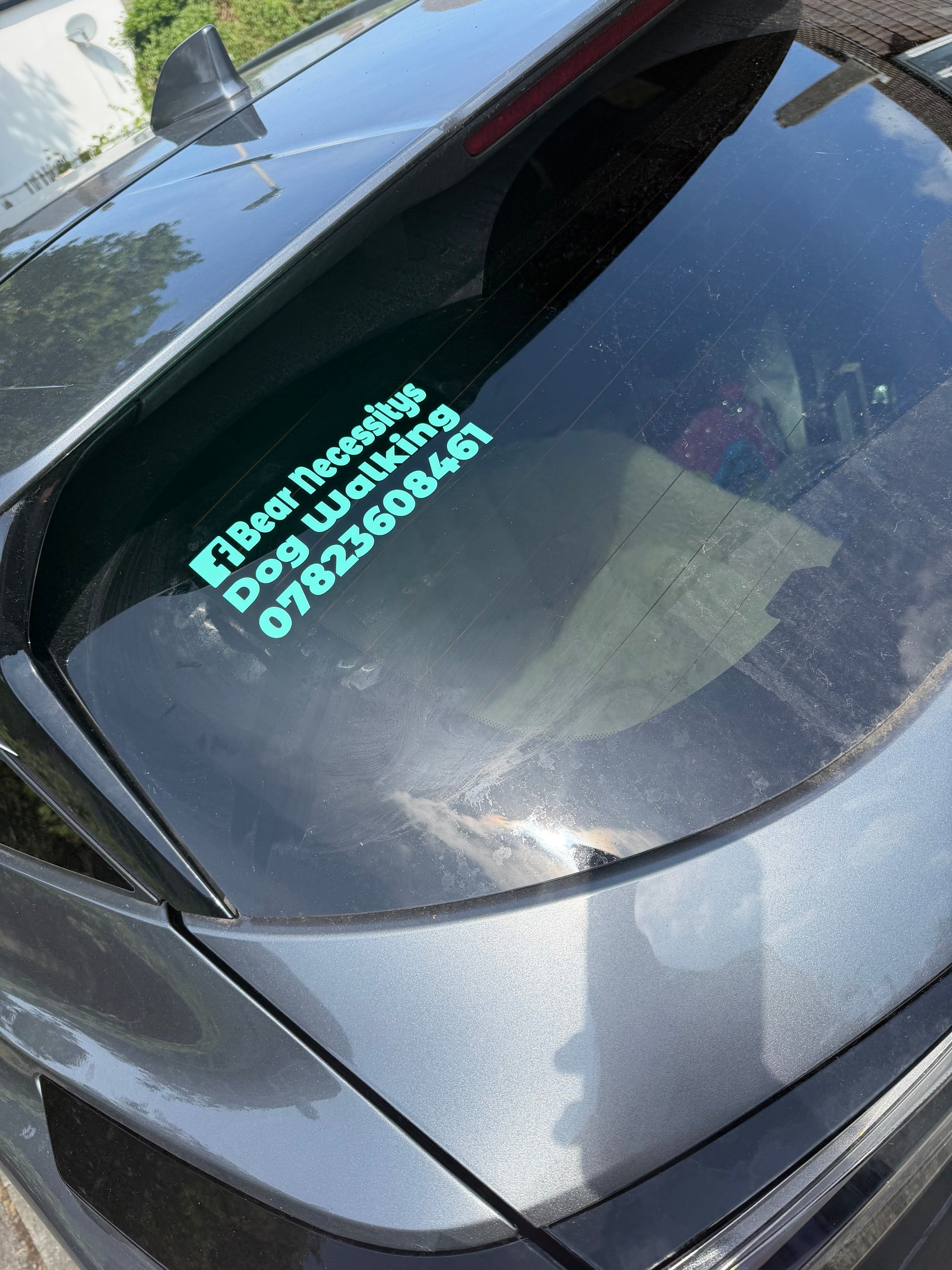 Car window with personalised car vinyl