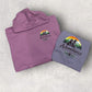 Two hoodies, one purple and one gray, with a 'Adventures with Friends' logo on a light gray background.